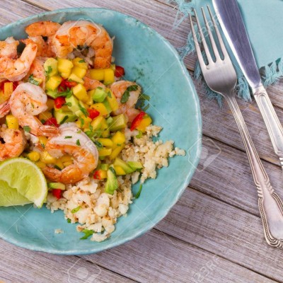 Shrimps with mango avocado and red pepper salsa on cauliflower rice